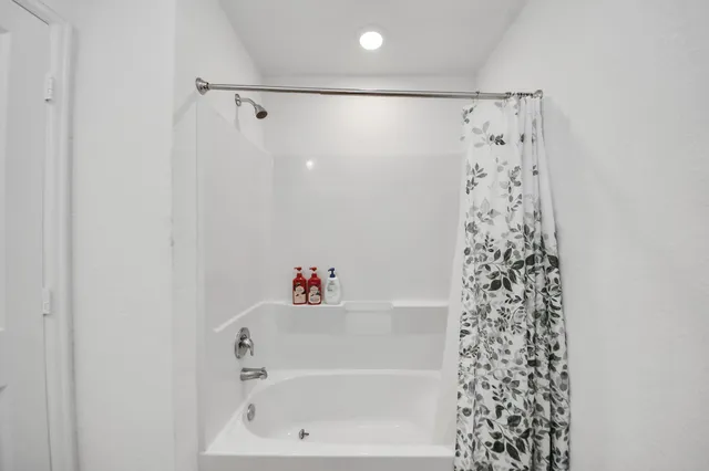 a bathroom with a bathtub and shower