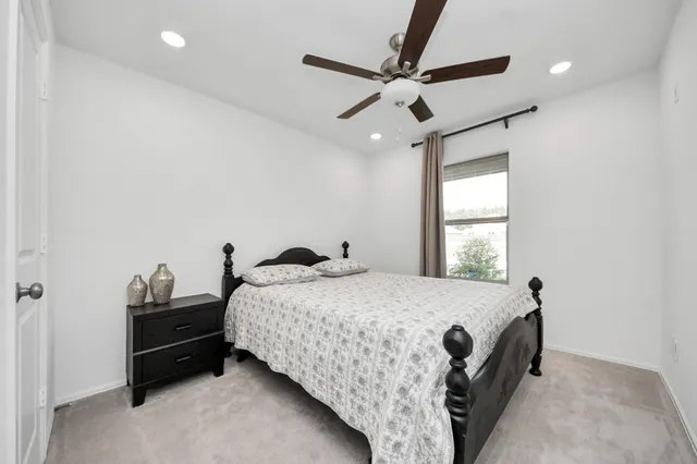 a bedroom with a bed and a ceiling fan