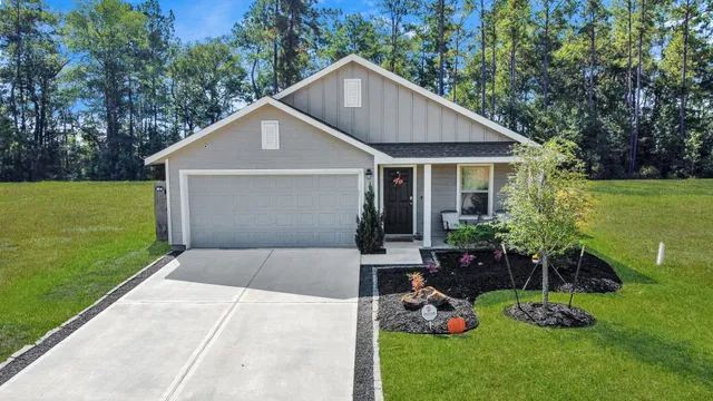 a front view of house with a garden