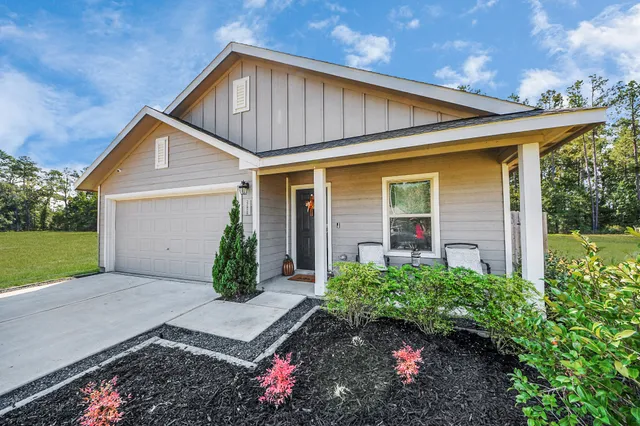 a front view of a house with garden
