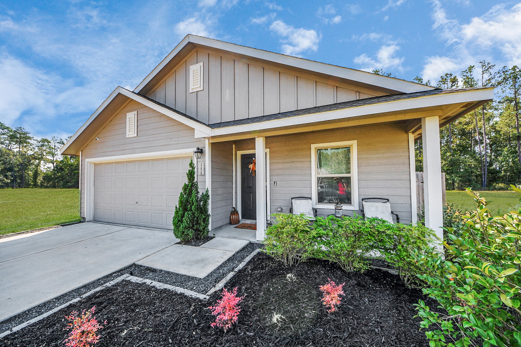22828 Great Egret Drive Splendora, TX 77372 - Photo 30 of 39 a front view of a house with garden