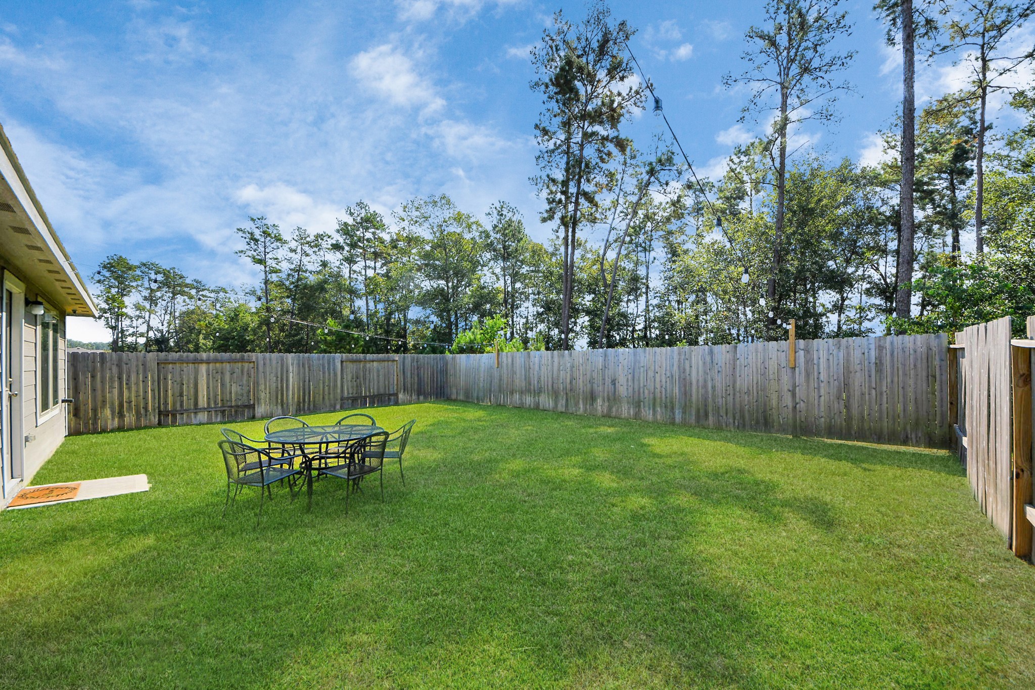 22828 Great Egret Drive Splendora, TX 77372 - Photo 33 of 39 a backyard of a house with table and chairs