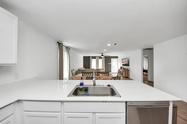 a room with a sink a bed and a window