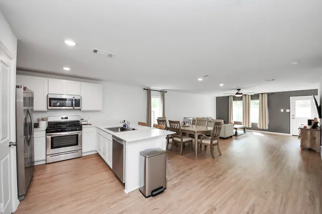 a large kitchen with a table and chairs