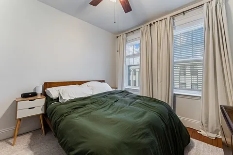 a bedroom with a bed and a window