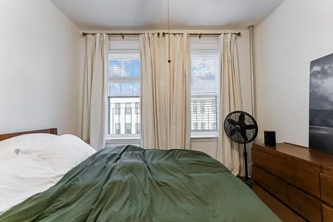 a bedroom with a bed and a window