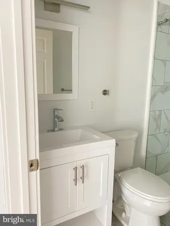 a bathroom with a sink toilet and mirror