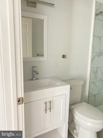 a bathroom with a sink toilet and mirror