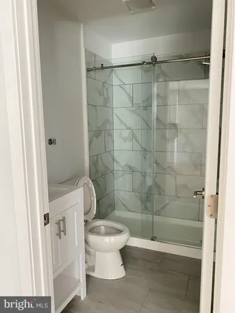 a bathroom with a toilet and shower