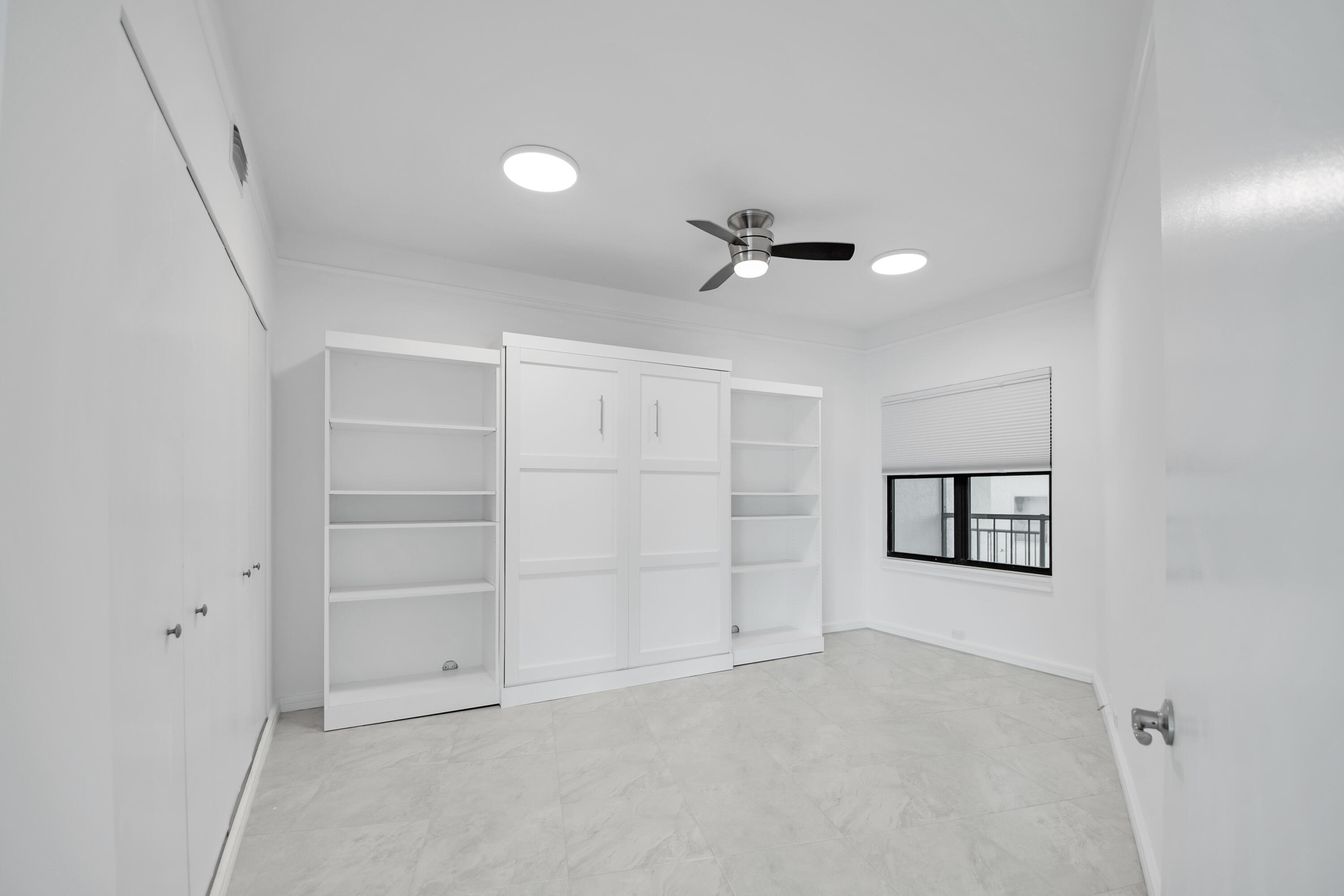 231 La Peninsula Boulevard, Unit 231 Naples, FL 34113 - Photo 15 of 42 a view of an empty room with a window