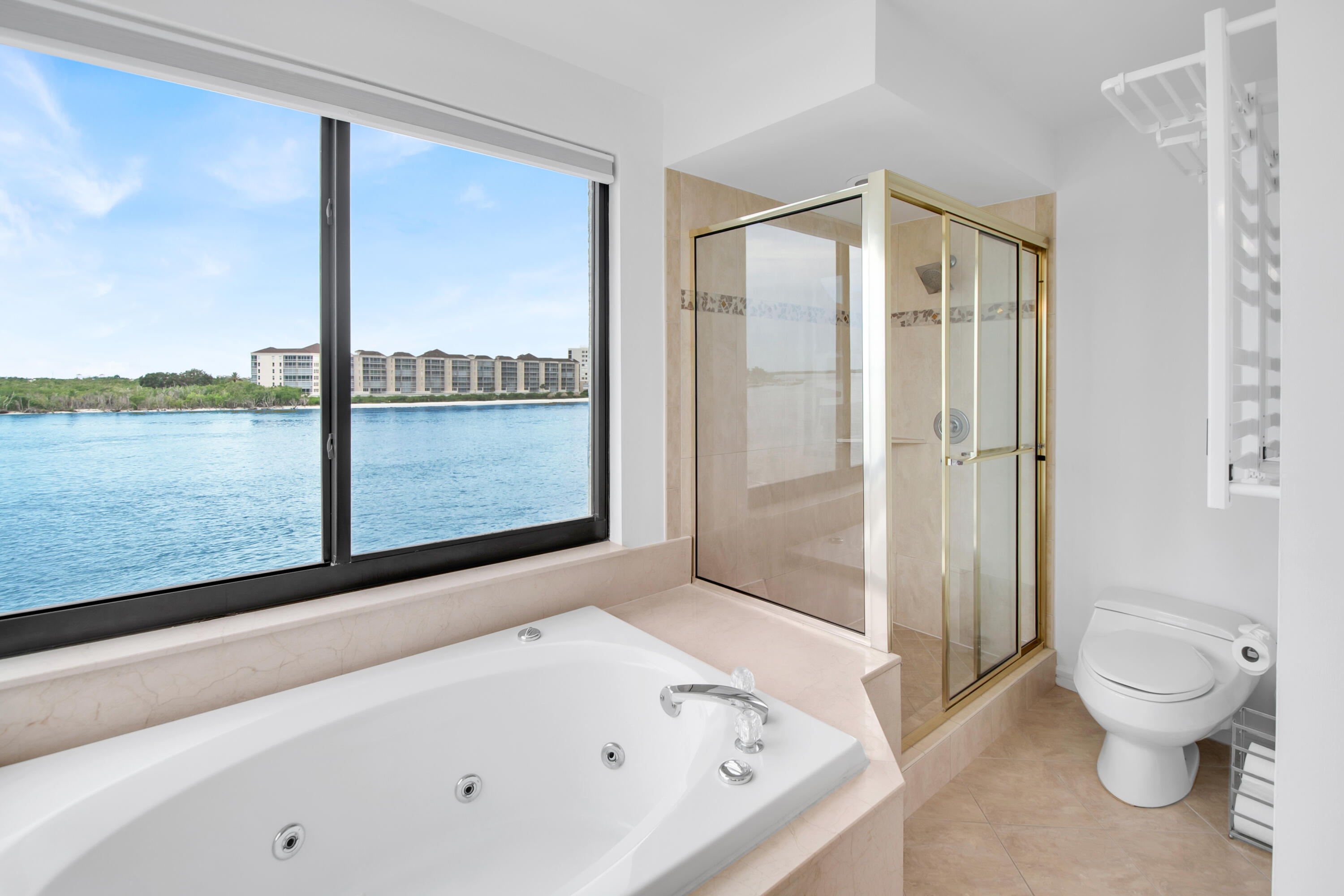 231 La Peninsula Boulevard, Unit 231 Naples, FL 34113 - Photo 22 of 42 a bathroom with a bathtub and a shower