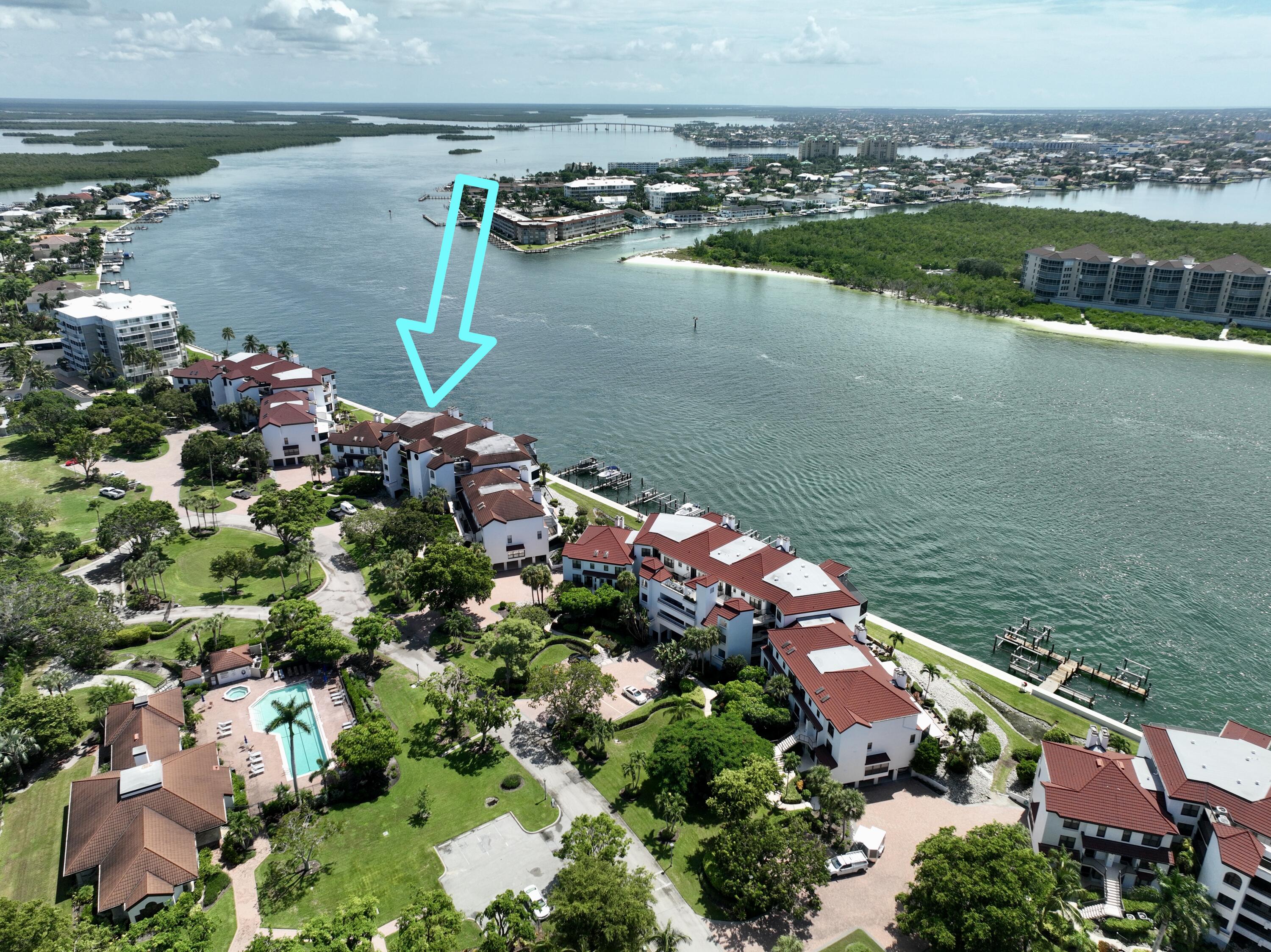 231 La Peninsula Boulevard, Unit 231 Naples, FL 34113 - Photo 30 of 42 a view of a lake with a lake