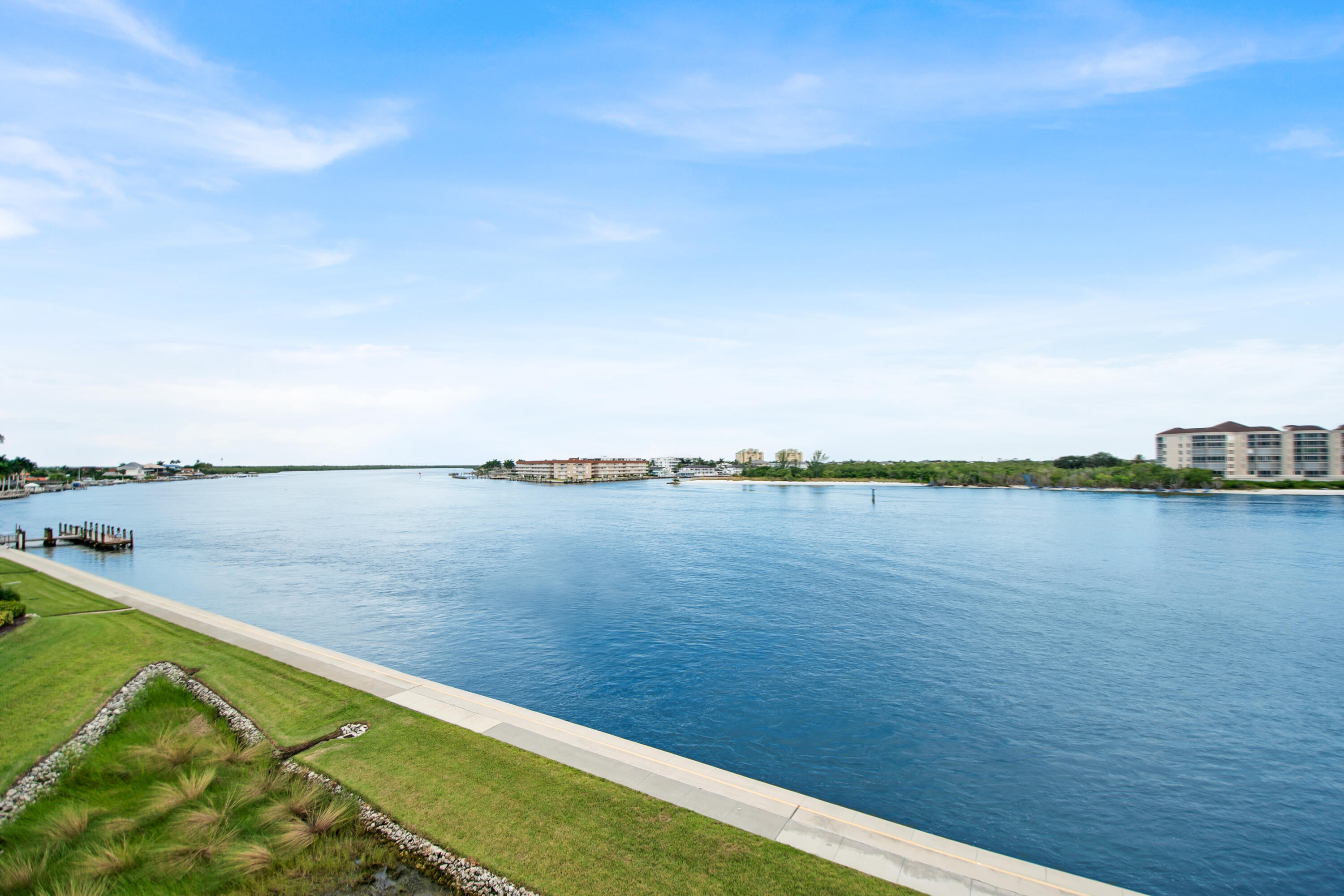 231 La Peninsula Boulevard, Unit 231 Naples, FL 34113 - Photo 7 of 42 a view of a lake from a yard