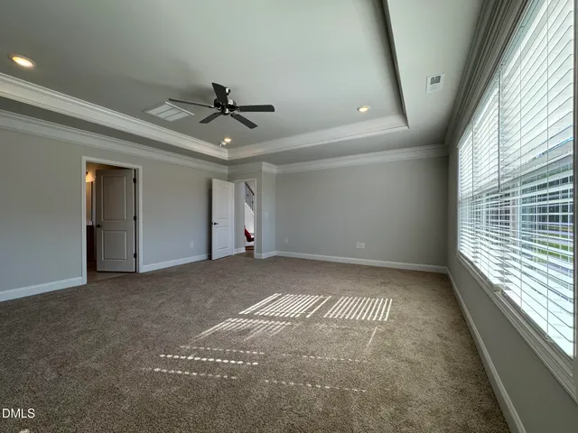 a view of a livingroom with a ceiling fan and window