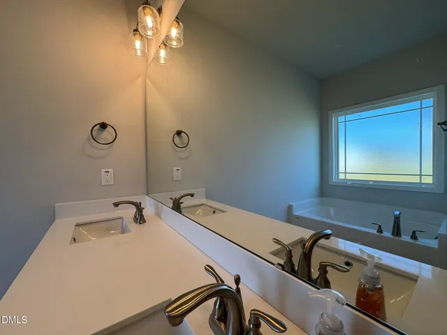 a bathroom with a tub and sink