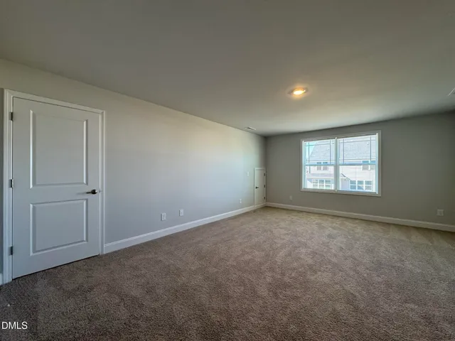 a view of an empty room and a window