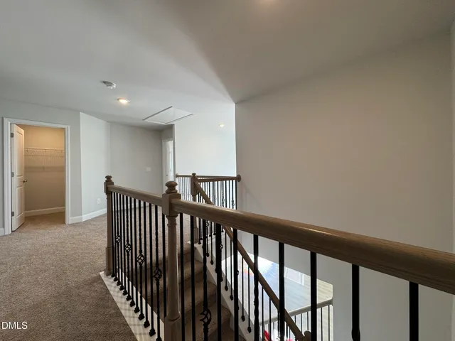 a view of staircase with rug