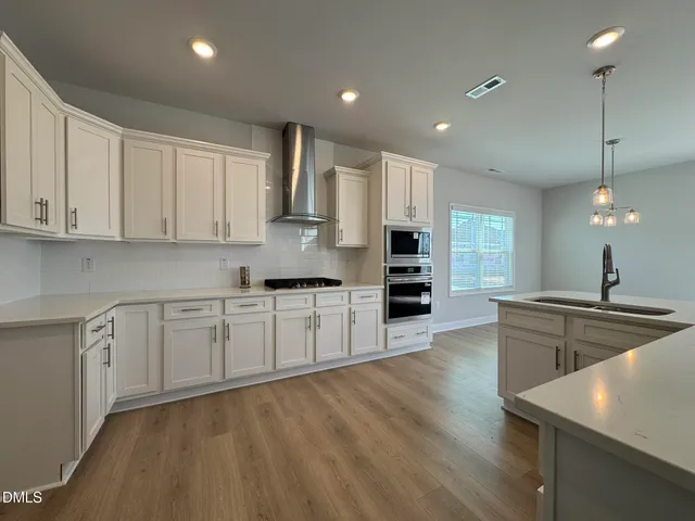 a kitchen with stainless steel appliances granite countertop a sink and cabinets