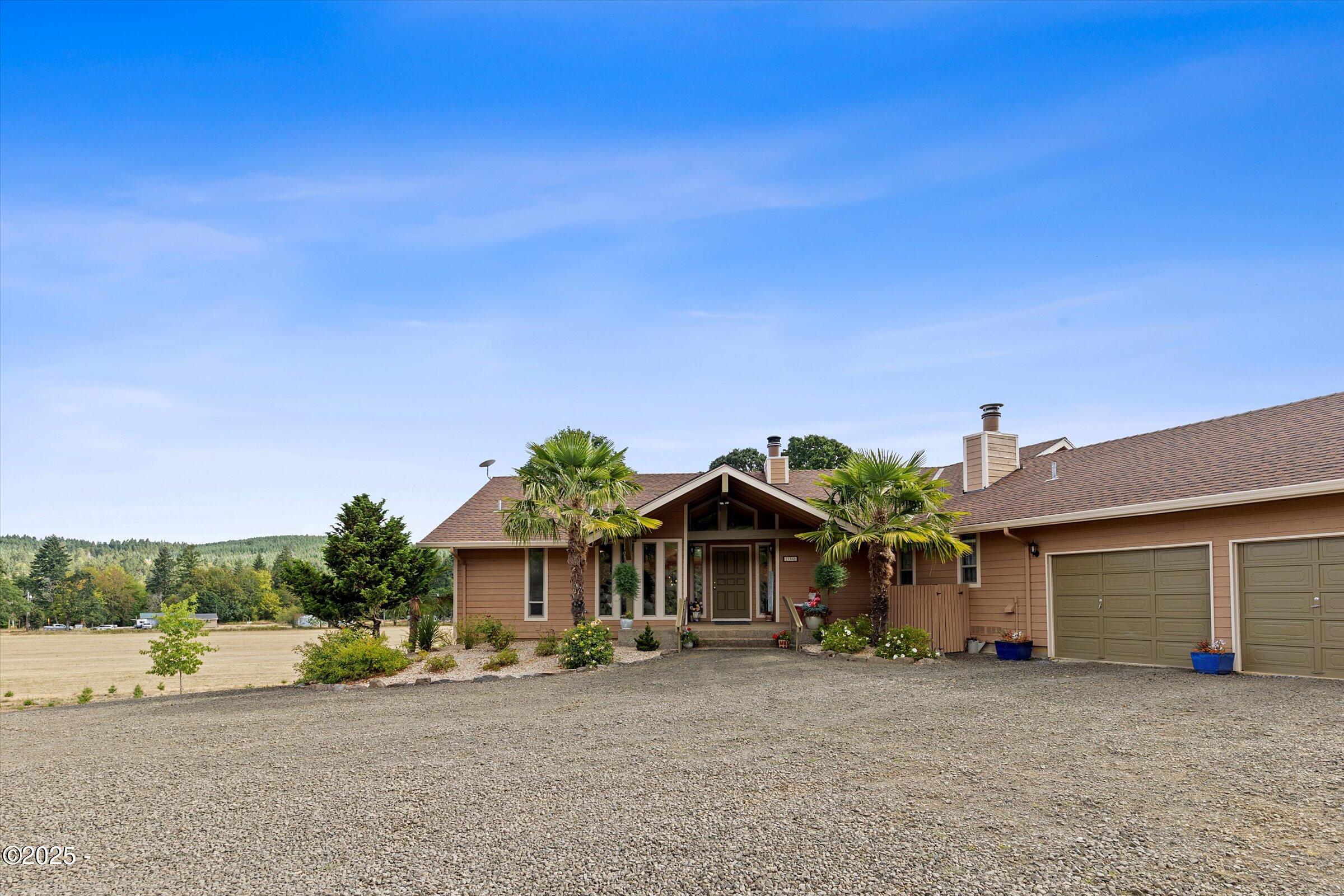 21560 Gooseneck Road Sheridan, OR 97378 - Photo 6 of 63 a front view of a house with a yard and a garage
