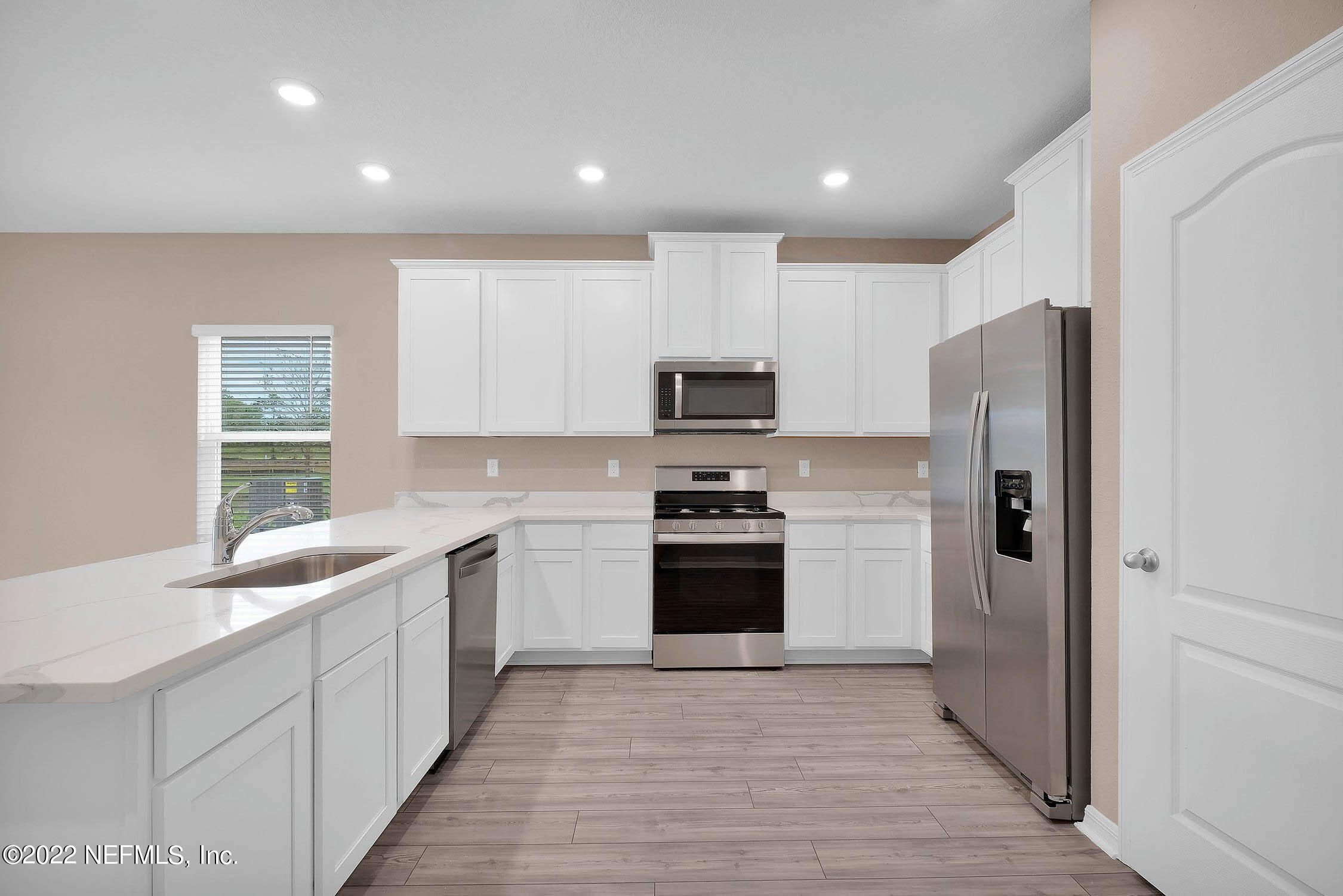 49 Falcon Ridge Road St. Augustine, FL 32084 - Photo 4 of 12 a kitchen with stainless steel appliances granite countertop a refrigerator sink and stove