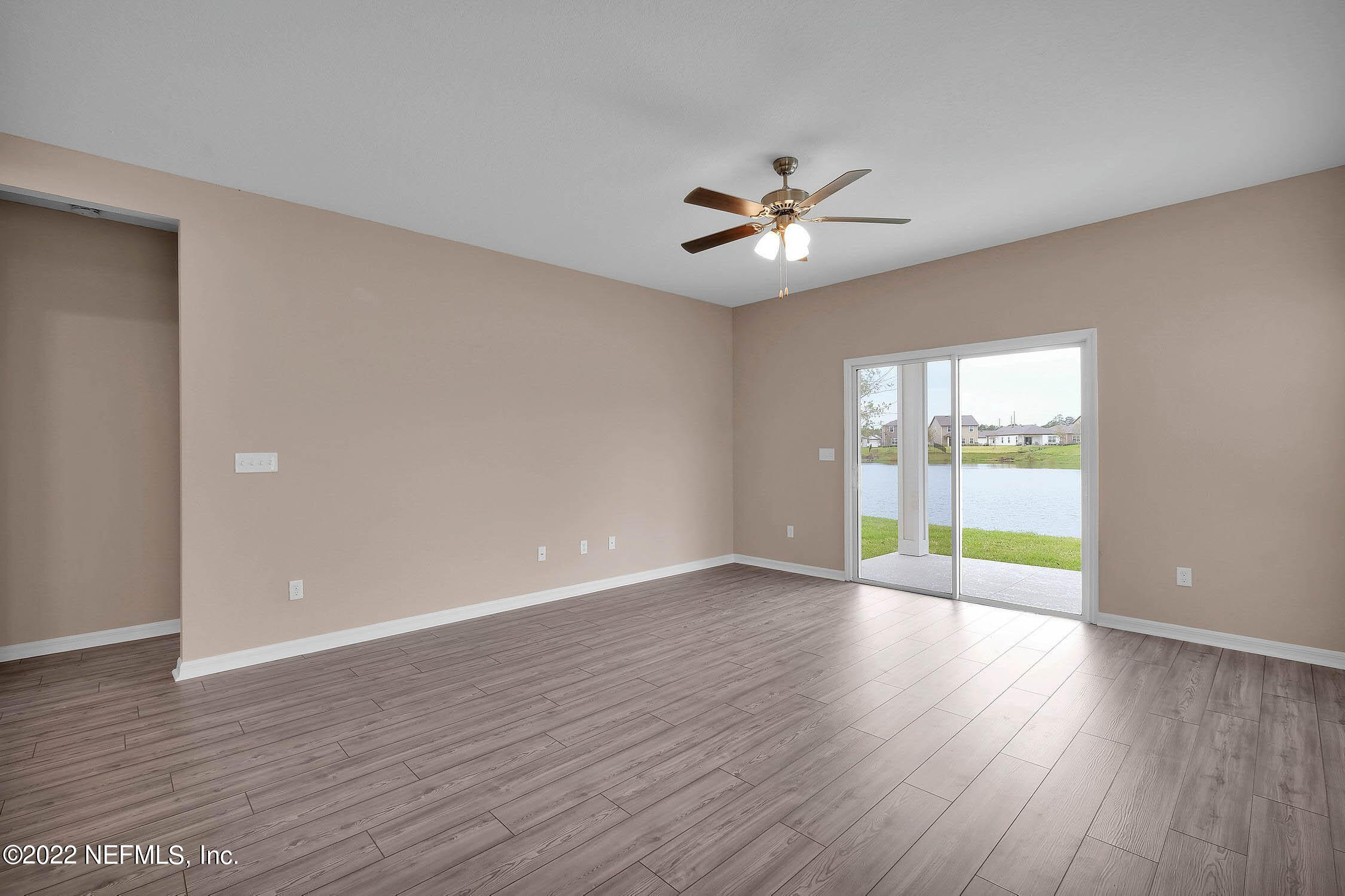 49 Falcon Ridge Road St. Augustine, FL 32084 - Photo 5 of 12 a view of an empty room with window and wooden floor