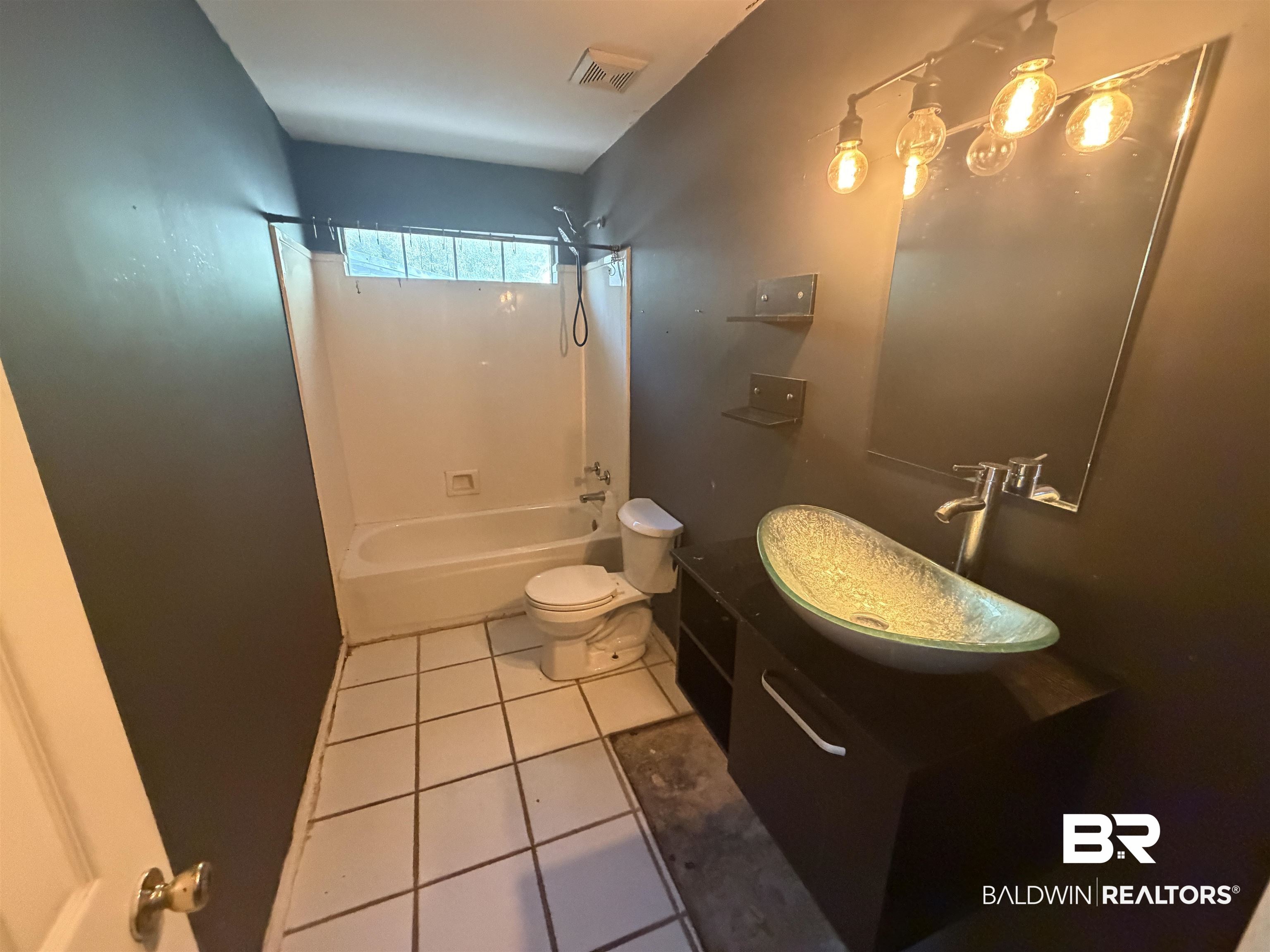 7067 Pinehill Road Daphne, AL 36526 - Photo 13 of 18 Bathroom featuring vanity, shower combination, and light tile patterned floors