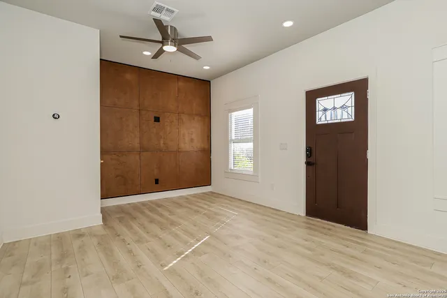 a view of an empty room with a ceiling fan