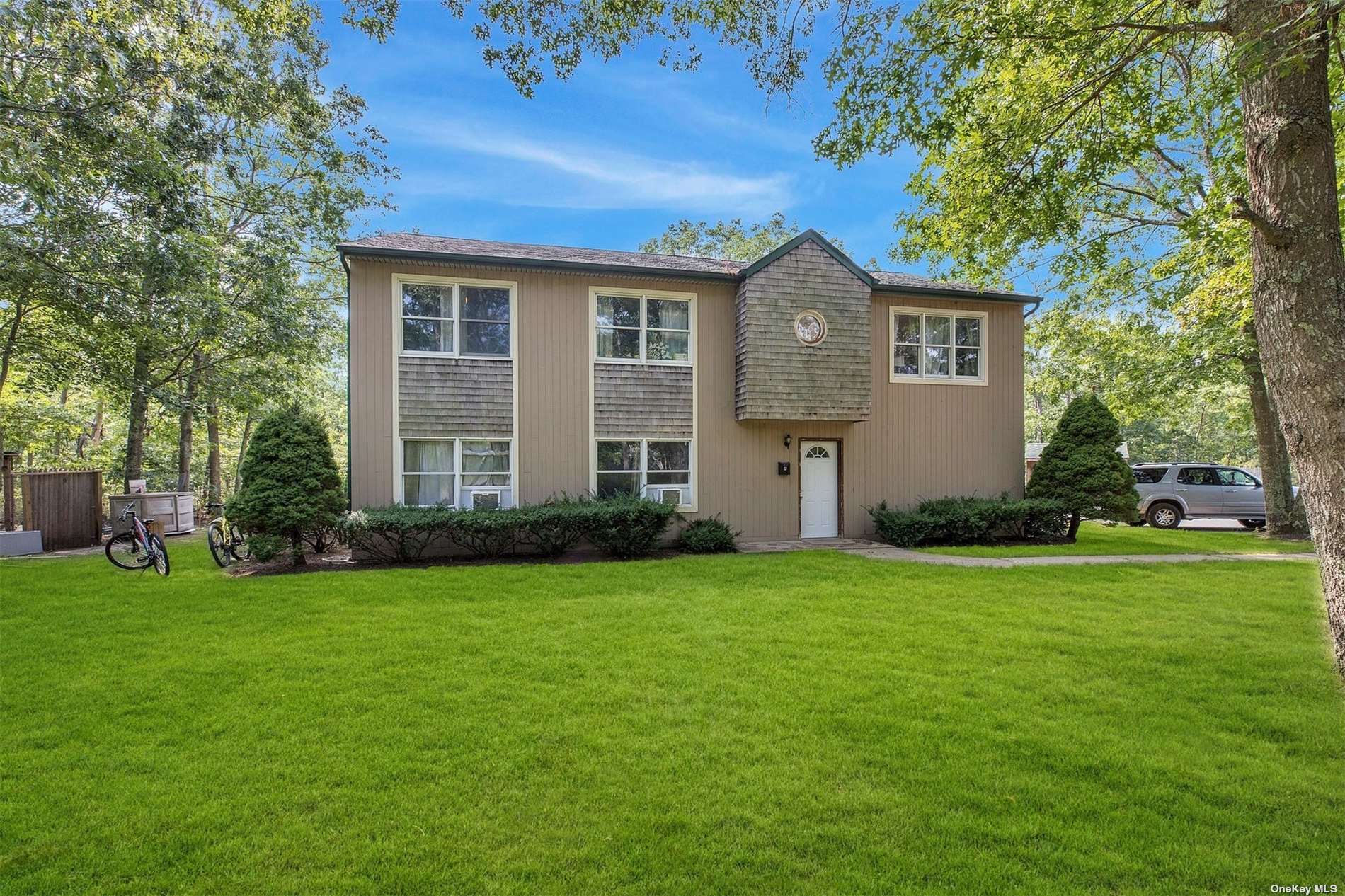 a front view of a house with a garden