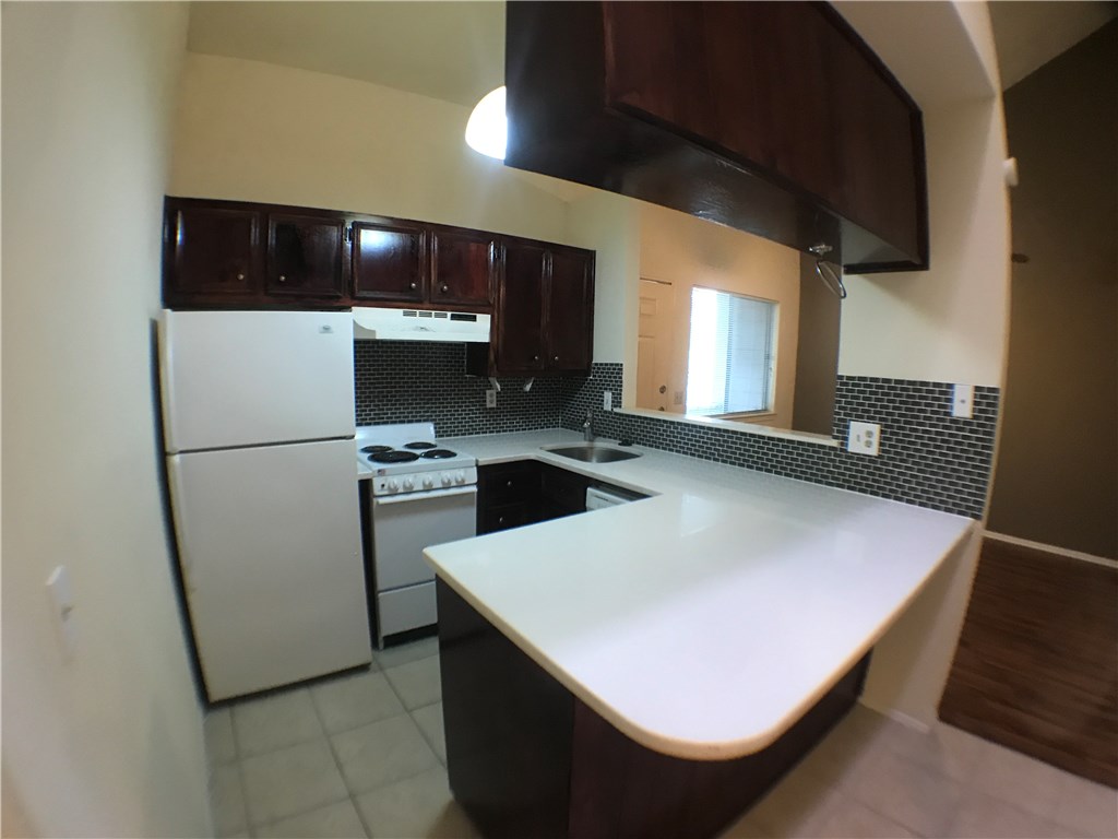 4411 Guadalupe Street, Unit 16 Austin, TX 78751 - Photo 2 of 2 a kitchen with a sink a refrigerator and a stove top oven