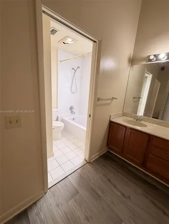 a view of bathroom with mirror toilet and sink