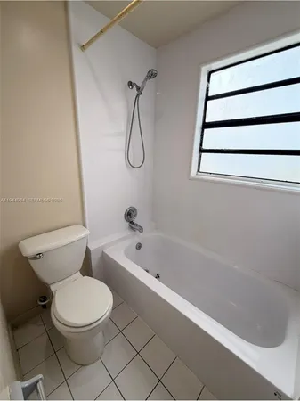 a bathroom with a toilet and a bathtub