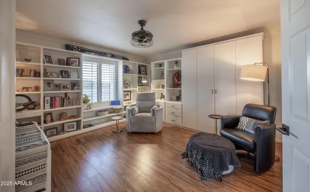 a living room with furniture and a book shelf
