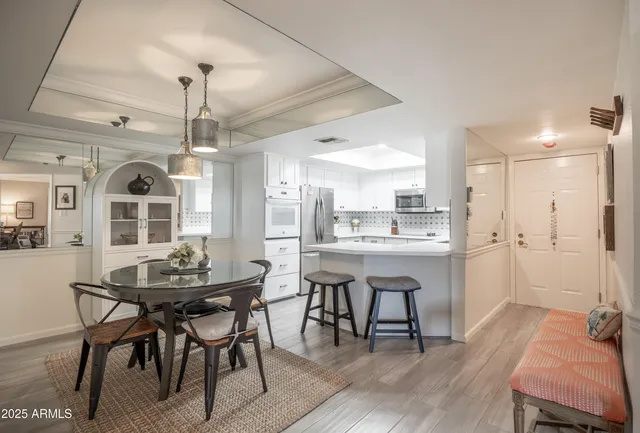 a view of a dining room with furniture and wooden floor