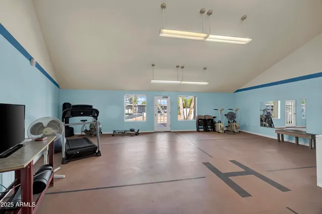 a room with gym equipment and a large window