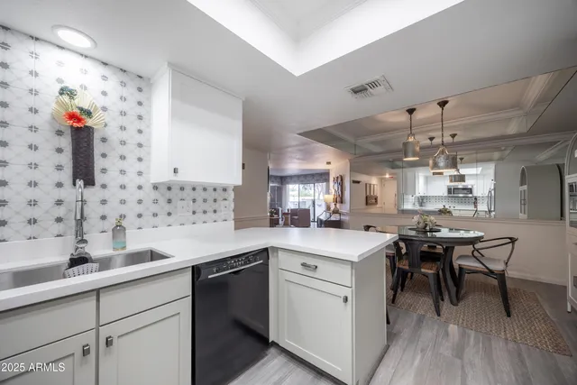 a kitchen with a sink cabinets and wooden floor
