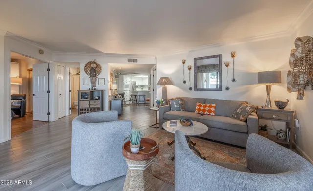a living room with furniture and a wooden floor