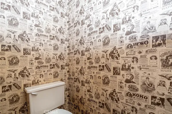 a bathroom with a toilet and a shower curtain