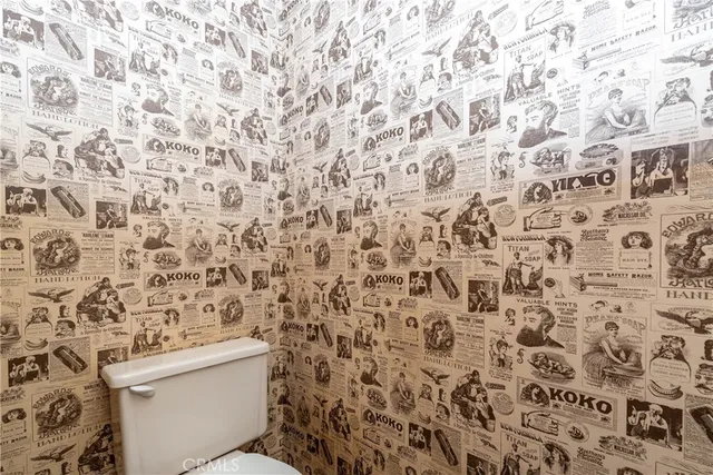 a bathroom with a toilet and a shower curtain