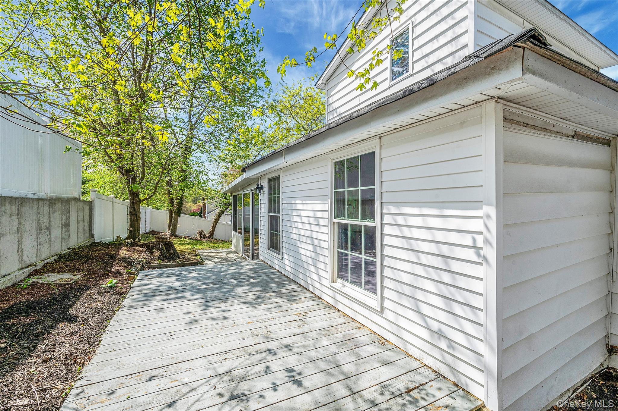 93 Maple Road Kings Park, NY 11754 - Photo 4 of 24 a backyard of a house with seating space
