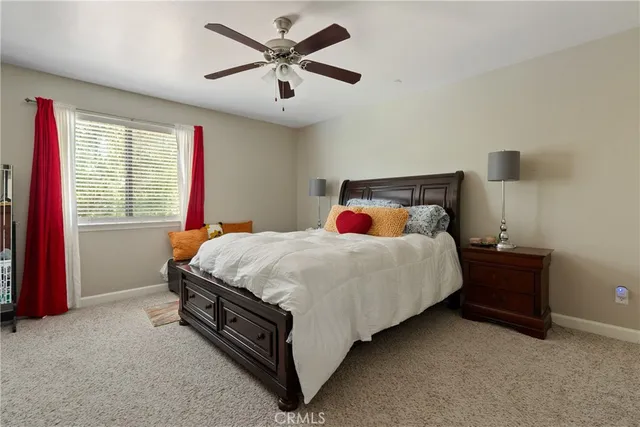 a bed sitting in a bedroom next to a window