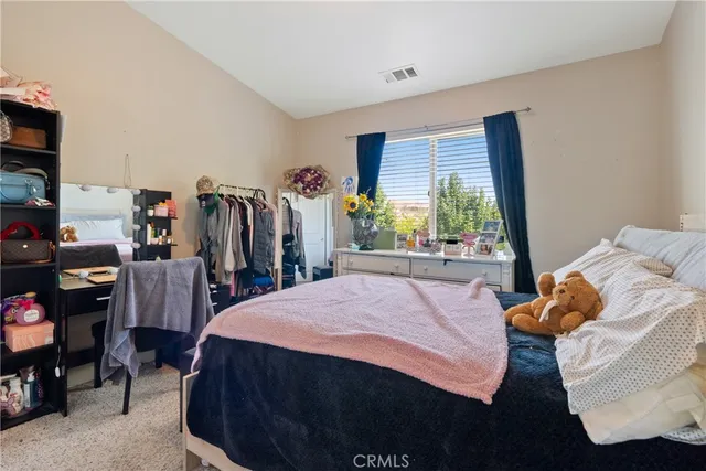 a bed room with a bed and a window