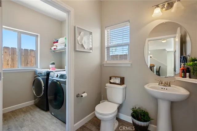 a bathroom with a sink toilet and a mirror