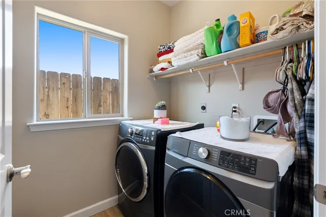 a utility room with sink dryer and washer
