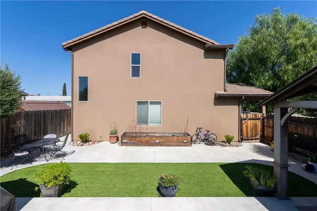 a view of a house with wooden deck and furniture