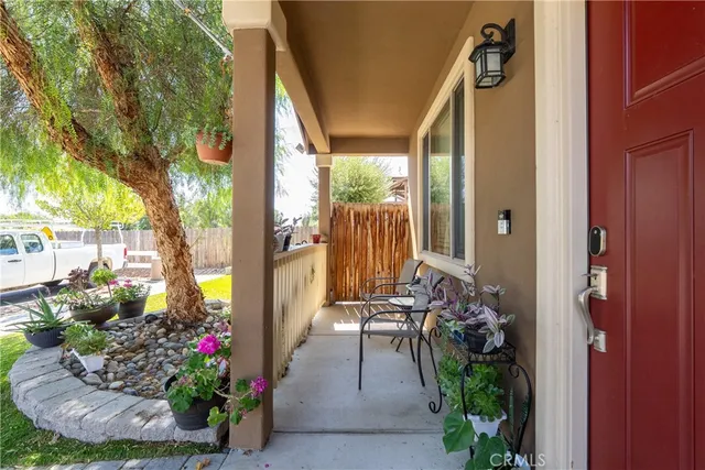 a view of a porch with furniture and garden