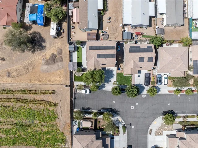 an aerial view of residential houses with outdoor space and parking