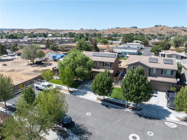 a view of a house with a swimming pool and a yard