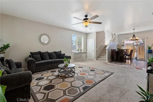 a living room with furniture and a chandelier