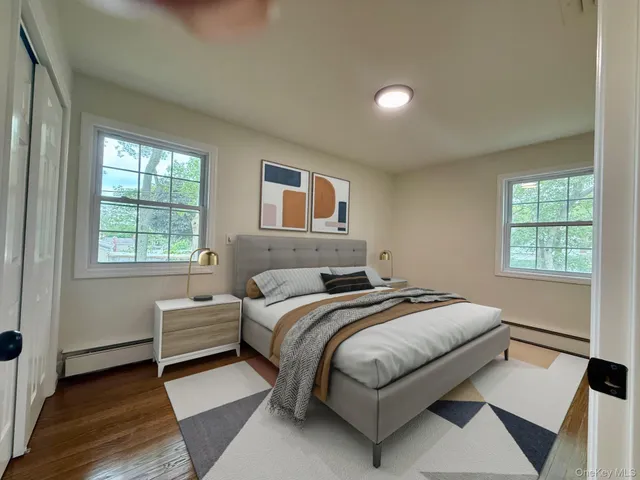 a bedroom with a bed lamp and a window