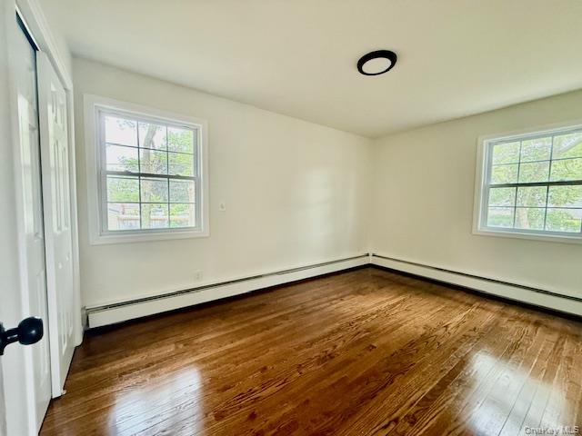 30 7th Street Holbrook, NY 11741 - Photo 16 of 22 an empty room with wooden floor and windows
